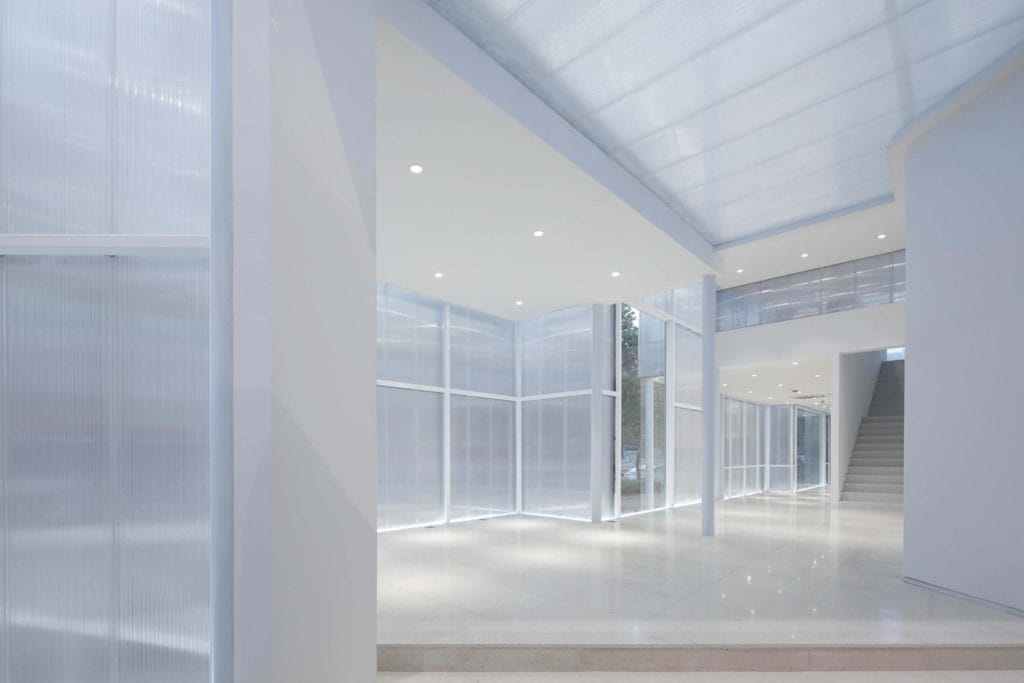 A domer skylight is featured in the image, its sleek design and clear polycarbonate material allow natural light to flood the room. It has a modern and minimalistic look with a white aluminum frame, which seamlessly blends with any architectural style. The skylight appears to be installed providing ample natural light to the interior space.