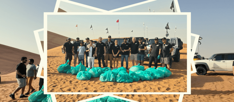 DOMER team standing in the desert beside collected bags of plastic waste after a successful clean-up initiative on May 3rd, 2025, demonstrating their commitment to sustainability and environmental responsibility.